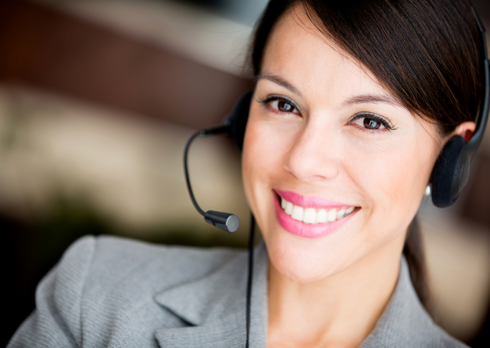 Friendly woman working at a call center smiling